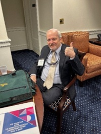 Partner, Russ Klemm seated and giving a thumbs up.